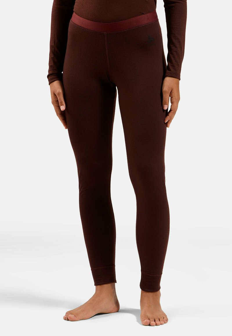 Brown thermal leggings with a contrasting waistband. Fitted design, stretchy material, and no visible patterns or logos. Barefoot model.