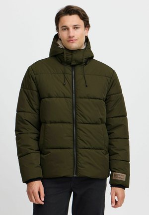 Olive green puffer jacket with a zip front, adjustable hood, and quilted texture. Features black accents and a fabric label on the sleeve.