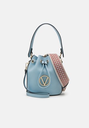 Light blue leather bucket bag with gold V logo, drawstring closure, top handle, and detachable red-white zigzag patterned shoulder strap.