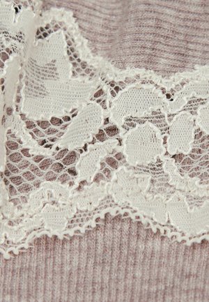 Light pink fabric with a ribbed texture features delicate white lace trim, showcasing floral patterns along the edge.