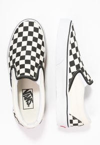 Sorte og hvide ternede slip-on sneakers med tekstiloverdel, gummisål og hvidt for. Har et struktureret mønster og logoetikette.