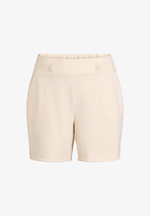 Beżowe szorty wykonane z miękkiej, gładkiej tkaniny. Posiadają elastyczny pas z dwoma guzikami oraz boczne kieszenie. Prosty krój nogawki.