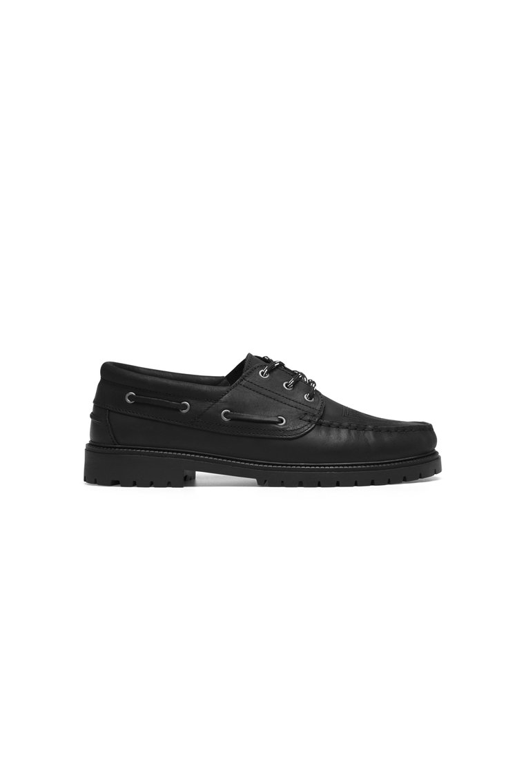 Black leather boat shoes with rounded toe, textured upper, lace-up design, and rubber sole featuring traction grooves.