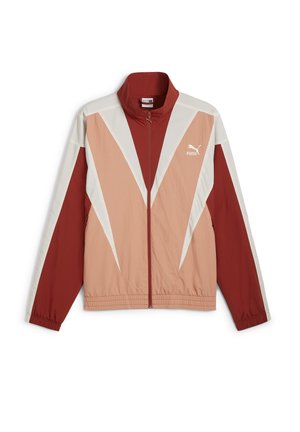 Piros és bézs szélálló dzseki magas gallérral, cipzáras záródással és éles geometriai színblokkolással. Rugalmas mandzsettákkal és derékpánttal rendelkezik.