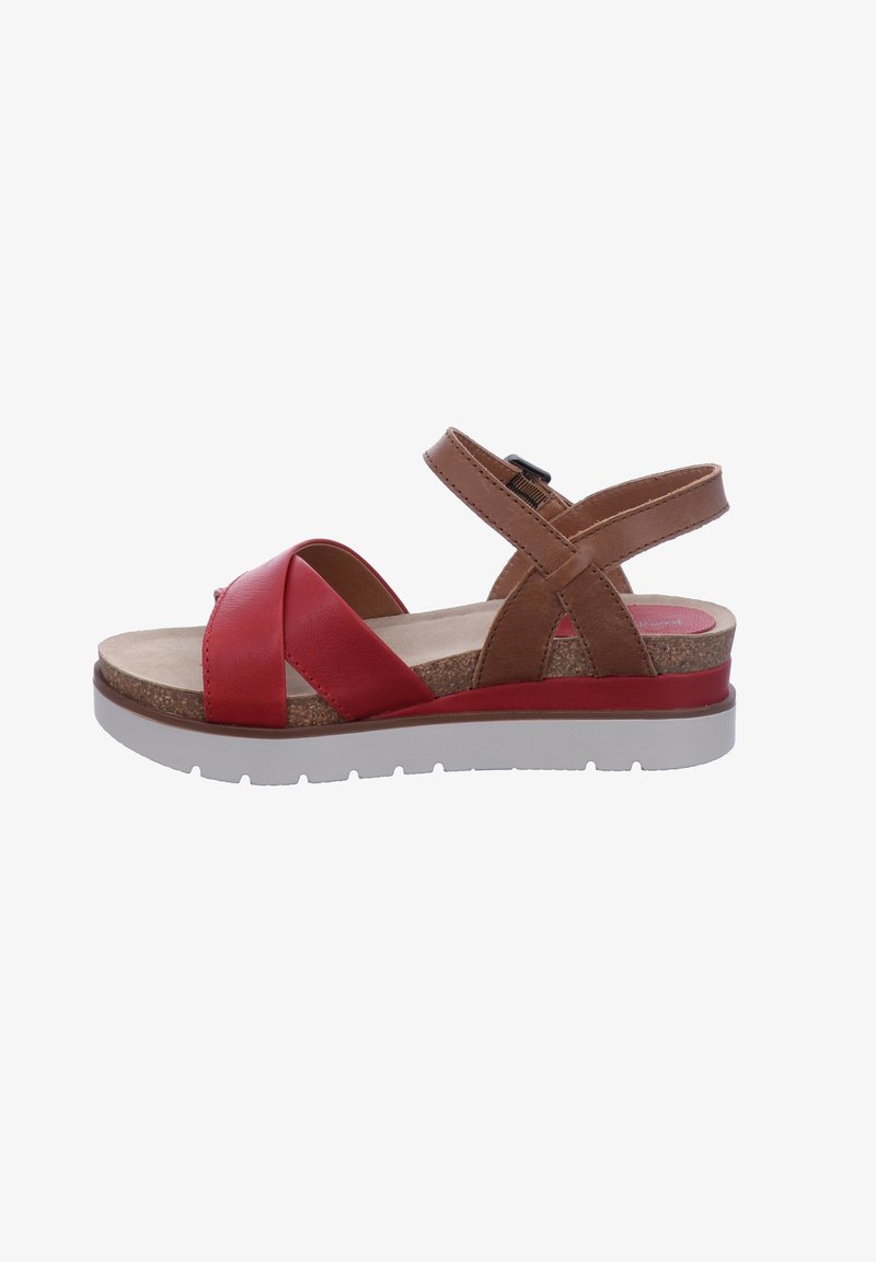Red and brown sandal with a cork insole, cross-strap design, adjustable ankle buckle, and a white rubber sole.