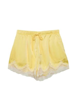 Gelbe Satin-Shorts mit weißem Spitzenbesatz am Saum und einem elastischen Bund, der vorne mit einem Kordelzug gebunden wird.