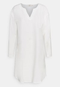 Biała lniana tunika z dekoltem w kształcie litery V, długimi rękawami i luźnym krojem. Posiada prosty dół i subtelną teksturę. Brak widocznych wzorów lub akcentów.