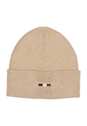 Beige ribbed knit beanie with folded cuff featuring a small horizontal tricolor logo in navy blue, white, and burgundy.