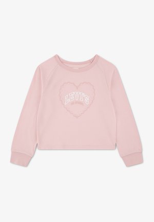 Chemise rose clair à manches longues avec col rond, ornée d'un motif cœur en petites perles et d'un texte blanc "LEVI'S" au centre.