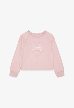 Chemise rose clair à manches longues avec col rond, ornée d'un motif cœur en petites perles et d'un texte blanc "LEVI'S" au centre.