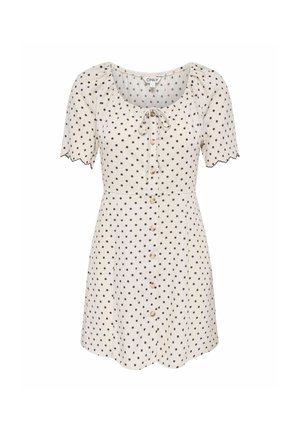 Krém rövid ujjú ruha fekete pöttyökkel, elülső gombokkal, hullámos ujjvégekkel és egy megkötővel a kivágott nyakkivágásnál.