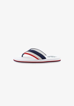 Flip-flop med vit sula och strukturerade remmar i marinblått, vitt och rött. Har ett randigt mönster och logotyp på fotbädden.