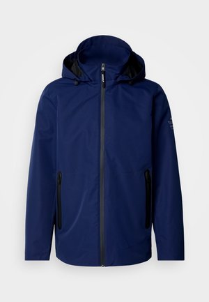 Navy blue waterproof jacket with a hood, front zipper, two black zippered side pockets, and subtle branding on the left shoulder.