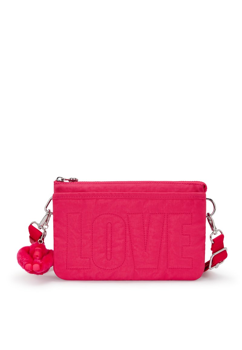 Pink fabric bag featuring embossed "LOVE" text, zip closure, adjustable strap, and a fluffy pink charm attached to the zipper.