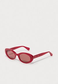 Red oval sunglasses with a glossy finish, featuring tinted lenses and metal accents on the arms. Smooth frame with rounded edges.