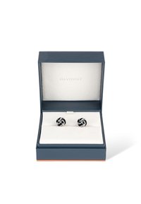 Black and silver cufflinks displayed in a navy box with a white interior. Cufflinks feature intertwined silver bands on a black base.