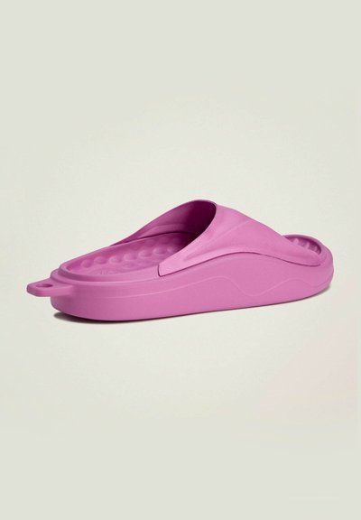 Pink rubber slide with a contoured footbed and open toe design. Smooth texture, rounded heel, and small pull-tab for easy wear.