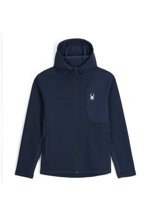 Marineblauwe zip-up jas met een getextureerd ribdesign, capuchon en een ritsborstas met een witte spinnenlogo aan de linkerkant.