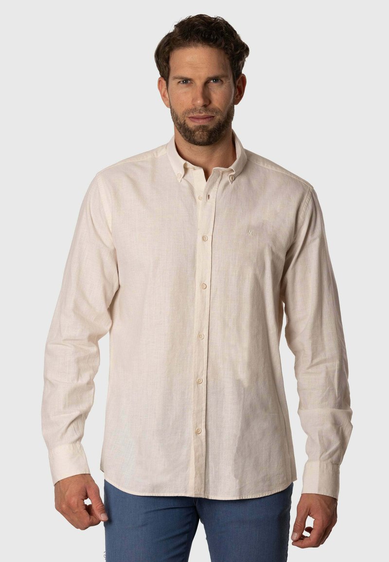 Camisa de manga larga, con botones, en beige claro, hecha de un tejido texturizado. Presenta un clásico cuello y un sutil logo bordado en el pecho.