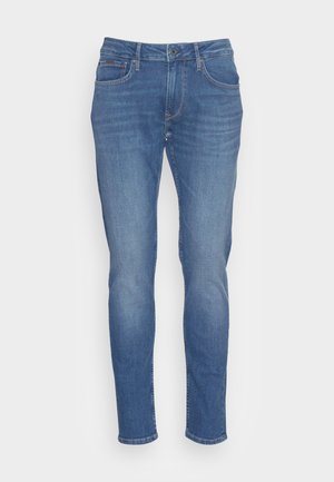 Jean en denim bleu à coupe slim, avec une fermeture à bouton et à zip à l'avant, cinq poches et un léger délavage sur l'ensemble du tissu.