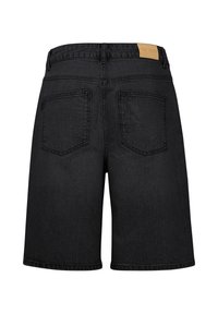 Short en denim noir vu de dos avec deux poches plaquées et une étiquette beige sur la ceinture indiquant Pulz Jeans.