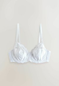 Fehér selyem melltartó csipke szélekkel, merevítő támogatással, állítható pántokkal és hullámos alsó széllel. Simá szövet és struktúrált kialakítás.