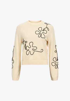 Kreemist sviitrilt musta lilleline tikkimine. Omab pikki varrukaid, soonikkoes mansette ja ümara kaelusega. Lühenenud stiil ja vabalt langev lõige.