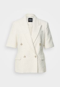 Blazer à manches courtes texturé de couleur crème, croisé, avec revers à cran, quatre boutons et poches avant à rabat.