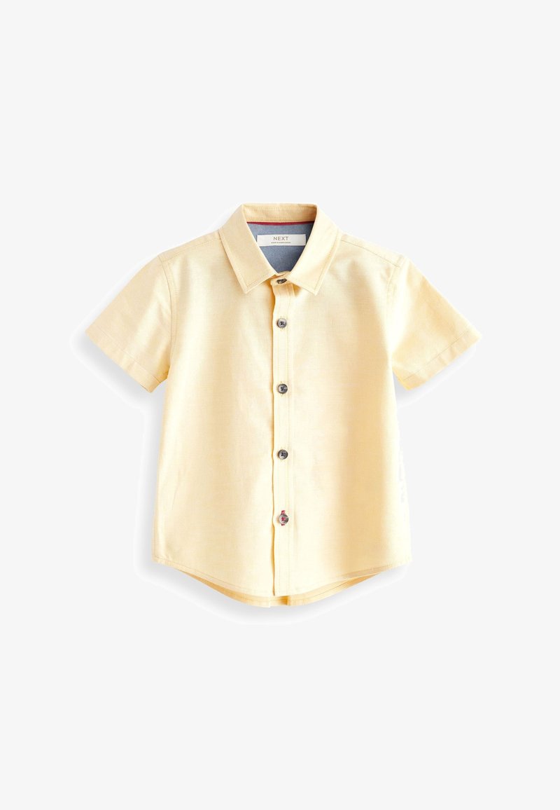 Chemise à manches courtes de couleur jaune pâle avec col et cinq boutons sombres, présentée à plat sur un fond blanc.