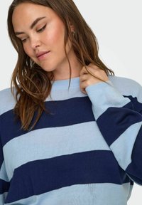 Blue and navy striped sweater with a round neckline and long sleeves, featuring a soft texture and a relaxed fit.