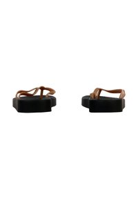 Chanclas de goma marrones con suela negra plana, que presentan un diseño minimalista y tiras delgadas, mostrando una superficie texturizada.