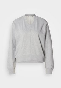 Harmaa collegepaita, jossa V-pääntie, pitkät hihat ja resorit hihansuissa. Valmistettu pehmeästä kankaasta, edessä saumaviiva ja lyhyempi malli.