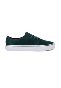 Green suede sneakers with a low-top design, white rubber sole, and black accents. Features rounded toe and standard lace fastening.