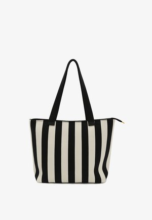 Torebka typu tote wykonana z materiału canvas w pionowe czarne i kremowe paski. Dwie czarne materiałowe uchwyty oraz zamek błyskawiczny u góry.
