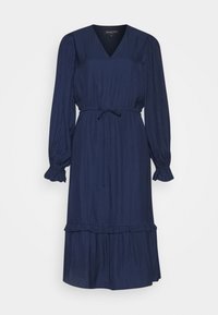 Námořnická modrá šaty s výstřihem do V, dlouhými rukávy, pruhovaným vzorem, elastickým pasem s tkaničkou a volánkovým lemem. Měkká, lehká tkanina.