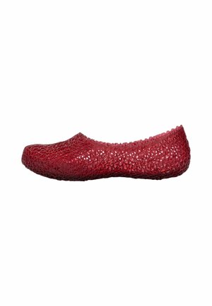 Red flat shoe with a lattice-like textured pattern and a slightly rounded toe, shown from the side on a white background.