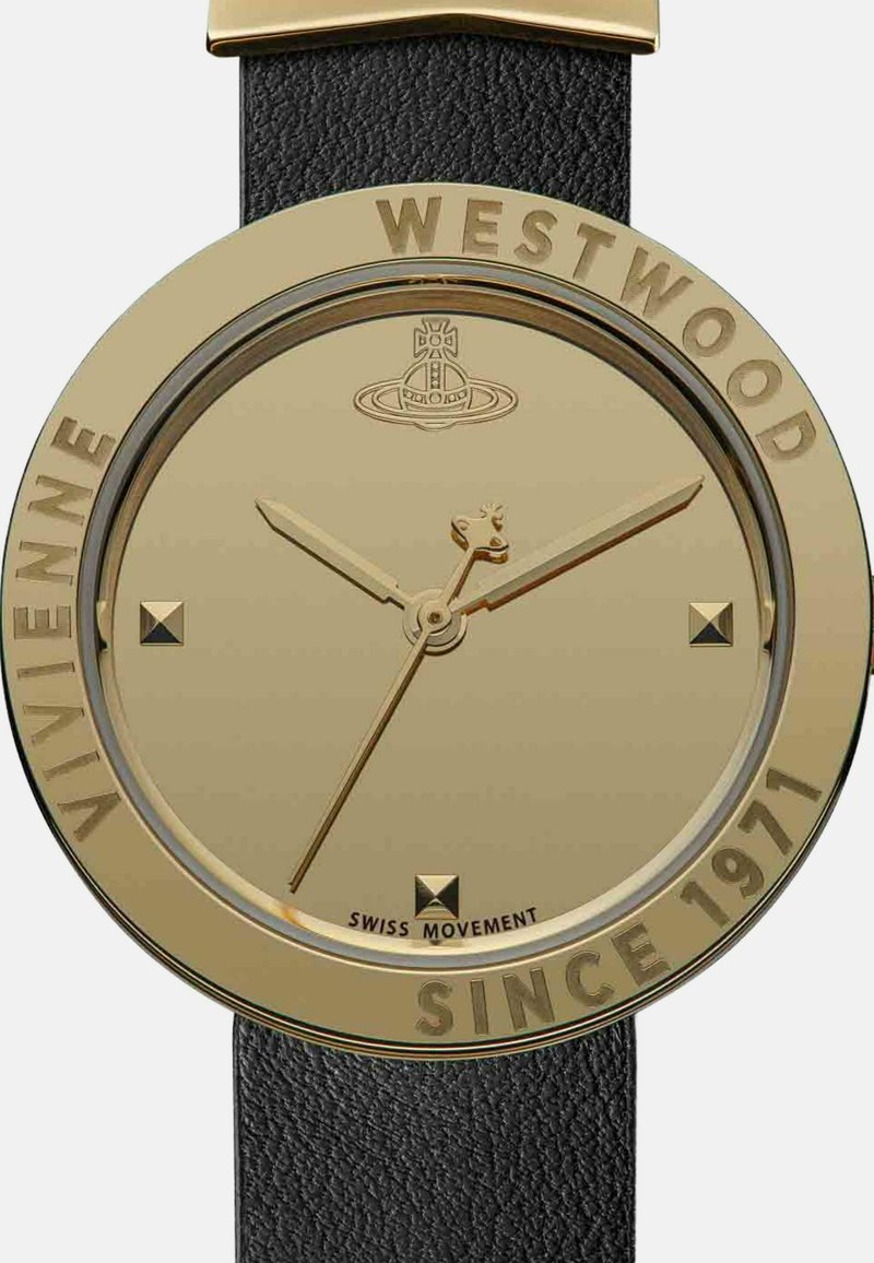 Round gold-tone watch featuring a minimalist dial with gold hands and square hour markers. Black leather strap. Text: "Vivienne Westwood" and "Since 1971."