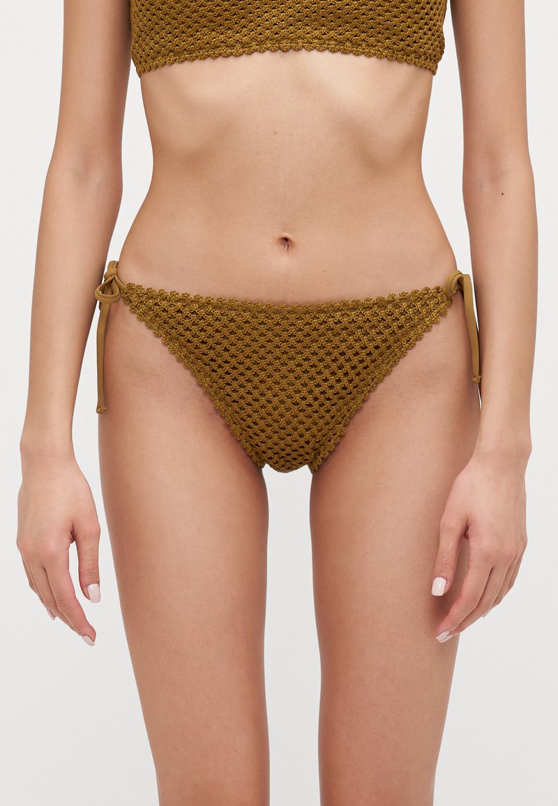 Brown crochet bikini bottom featuring a textured, diamond pattern and adjustable tie sides for a customizable fit.
