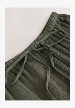 Olívazöld pliszírozott szoknya texturált anyagból, rugalmas derékpánttal és elöl megkötővel.