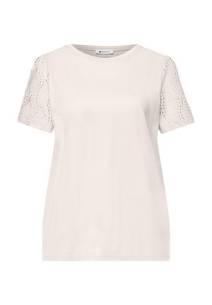 Haut beige pour femme à manches courtes avec encolure ronde et détails en dentelle à motifs sur les manches, étiqueté "Street One" à l'intérieur du col.