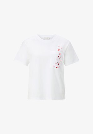 Tricou alb cu mânecă scurtă și buzunar frontal decorat cu inimioare mici roșii și roz împrăștiate în partea superioară dreaptă.