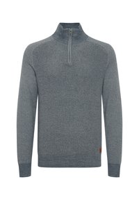 Gray pullover sweater with a half-zip collar, textured fabric, flat seams, and a small brown leather logo patch at the hem.