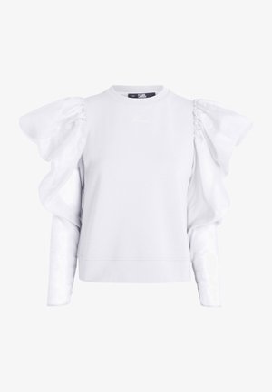 Hvid bluse med lange ærmer og puffer af organza samt diskret "Karl" broderi på brystet, med rund halsudskæring.