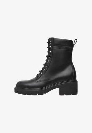 Black leather ankle boot with lace-up front, silver eyelets, rounded toe, and chunky heel. Features a pull tab on the back.