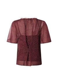 Blouse bordeaux à pois avec manches courtes transparentes, col à volants et détails de boutons à l'avant. Texture légère et semi-transparente.