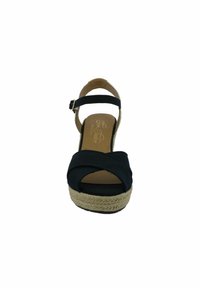 Women's black platform sandal with adjustable ankle strap and woven espadrille sole, front view.