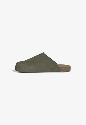 Olive green suede slip-on clog with a rounded toe, cork sole, and a smooth texture. Features a slight heel and subtle stitching details.