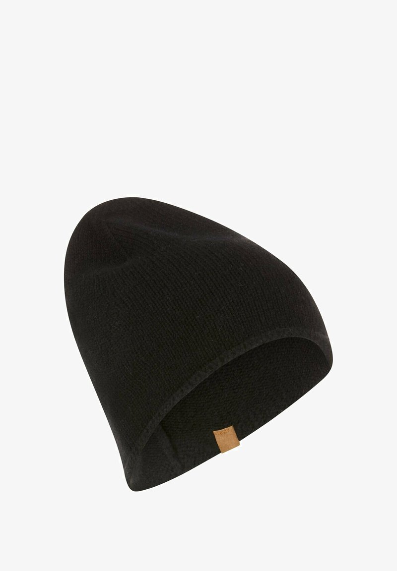Black knitted beanie with a smooth texture and a slightly elongated shape. Features a small brown leather tag on the side.