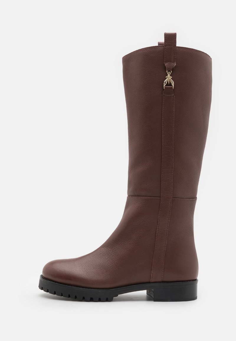 Brown knee-high boot made of leather, featuring a textured surface, flat rubber sole with grip, and a decorative accent on the back.