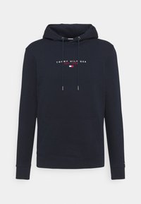 Sudadera de marina con cordones, bolsillo frontal y logotipo bordado de "Tommy Hilfiger" con el año de establecimiento. Material de algodón suave.
